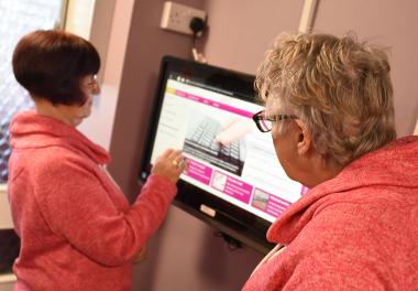 Residents at Bishop Ramsay Court using the touch screen computer